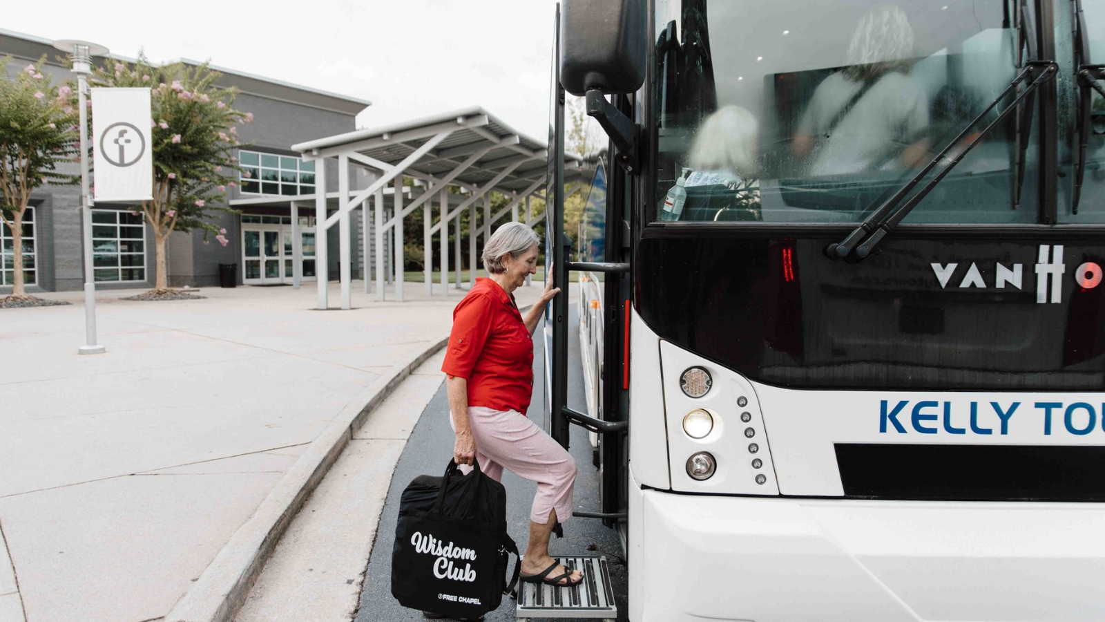a woman boarding a charter bus